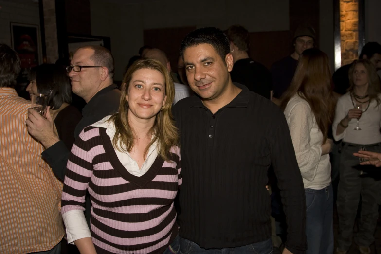 two people at an event standing together smiling