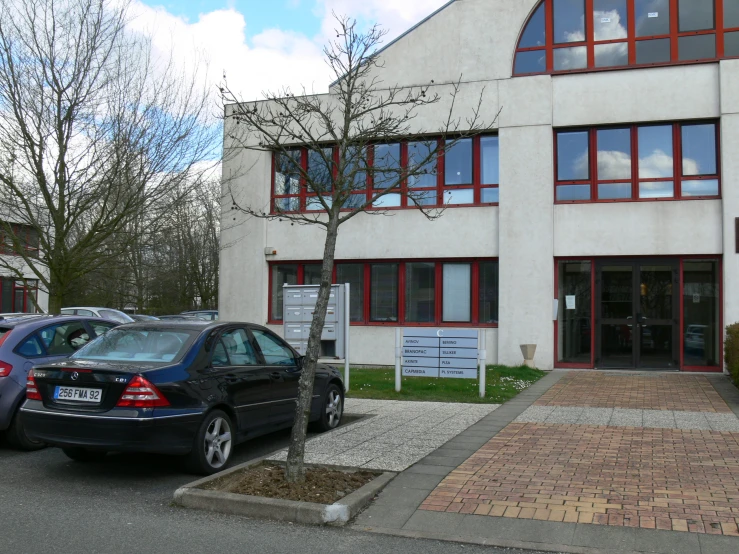 there are many cars parked in front of this building