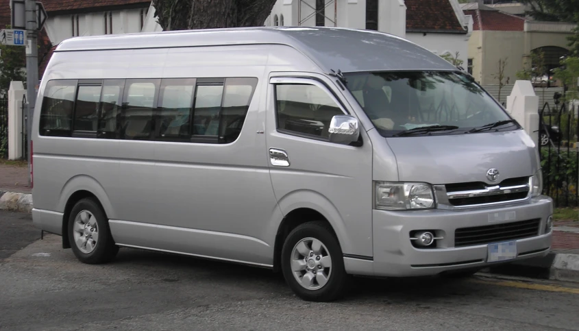 a silver van is parked on the street