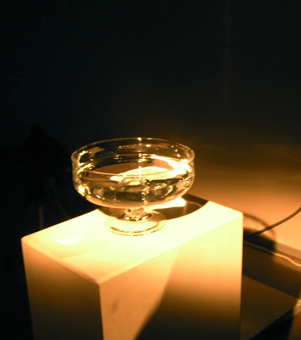 a glowing bowl sitting on top of a small pedestal