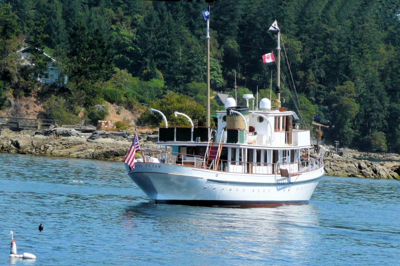 a boat that is in the water with some trees in the background