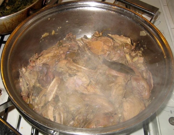chicken is cooked in the kitchen and is in a pan