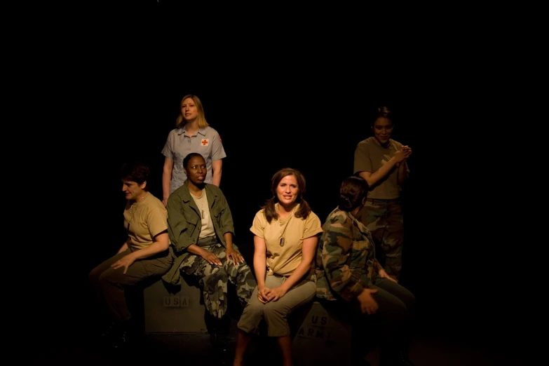 a group of people sitting on top of a cement bench