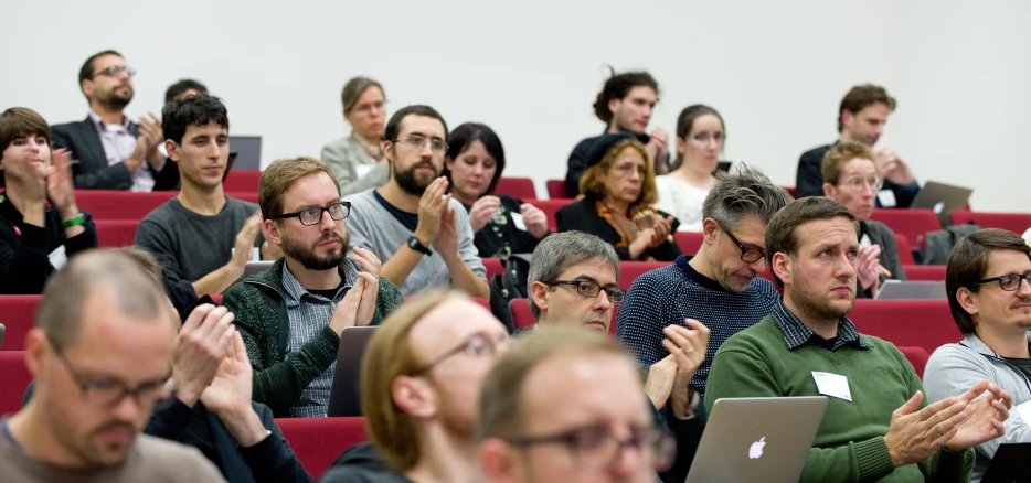 a group of people at a presentation with some of the people clapping