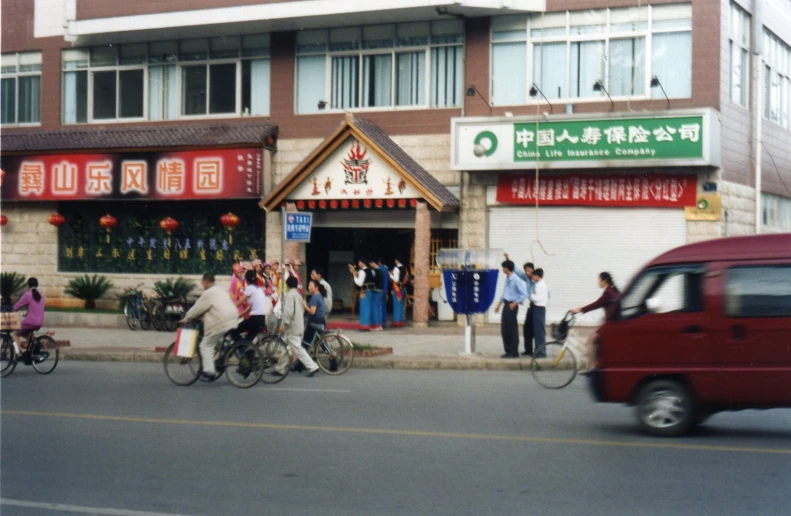 several people are on bicycles in front of a store