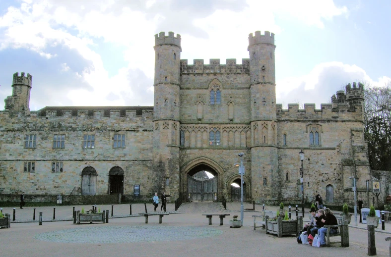 a castle with several people on the courtyard