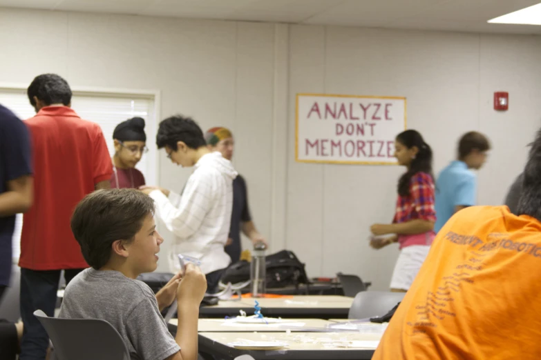 several students with their bags at tables during a quiz