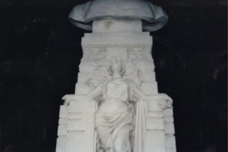 a monument is displayed with some statues inside