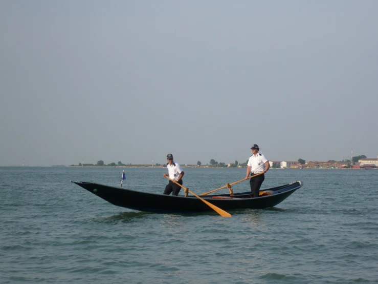 two men in small boats in the ocean