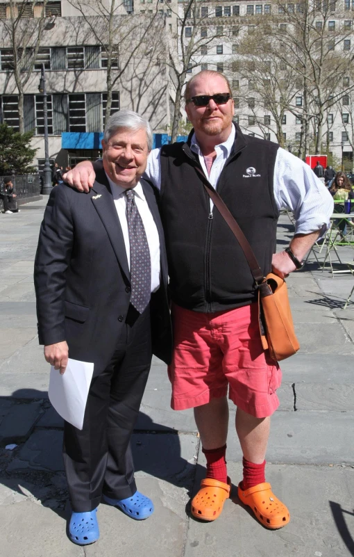 two men standing next to each other, in shorts