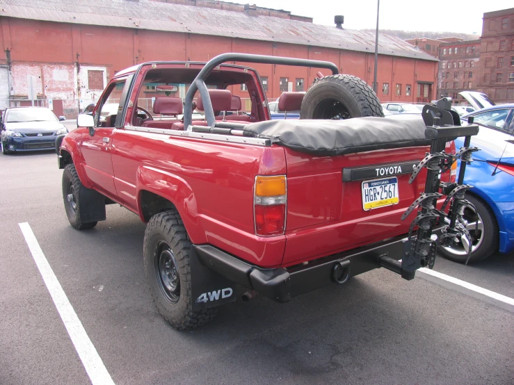 a pick up truck with the flatbed removed sitting in a parking space