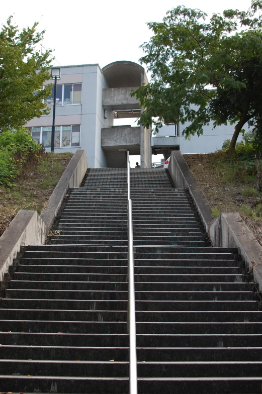 stairs lead up to a two story apartment building