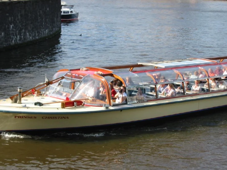 a tourist boat with tourists sails along the river