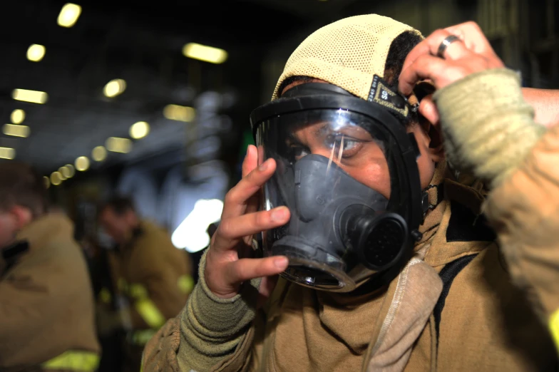 a man wearing a jacket and face mask holding soing