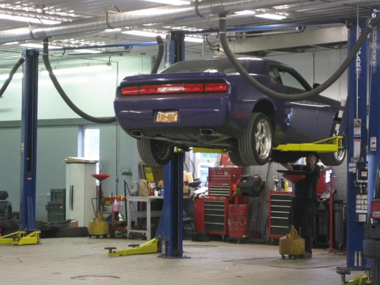 a car is in the air on a lift