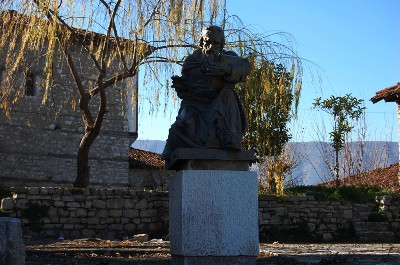 a statue of a man standing with his hands on his hips