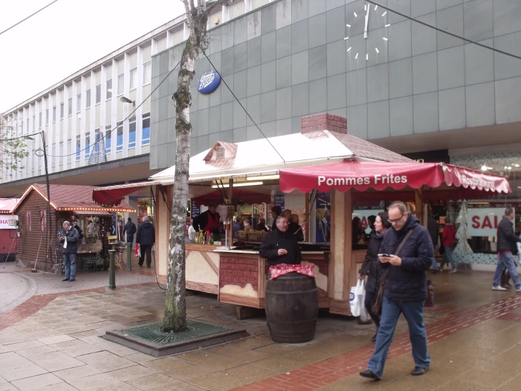 a group of people walking around an outside market