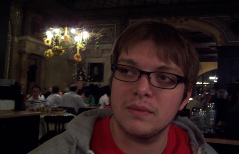 man looking at camera in a restaurant at night