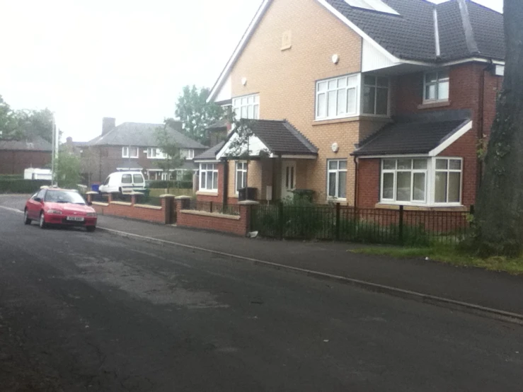 a car is parked in front of some houses