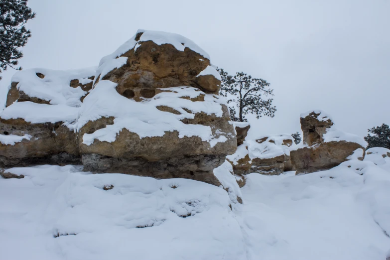 a ski boarder on a snow covered cliff