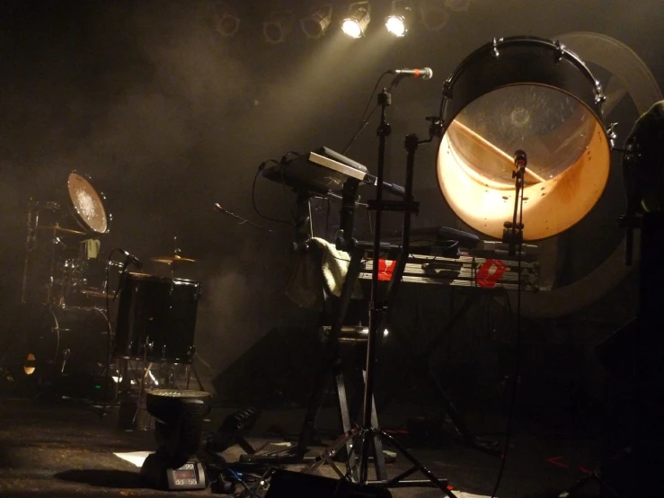 a drum set up in front of stage lights