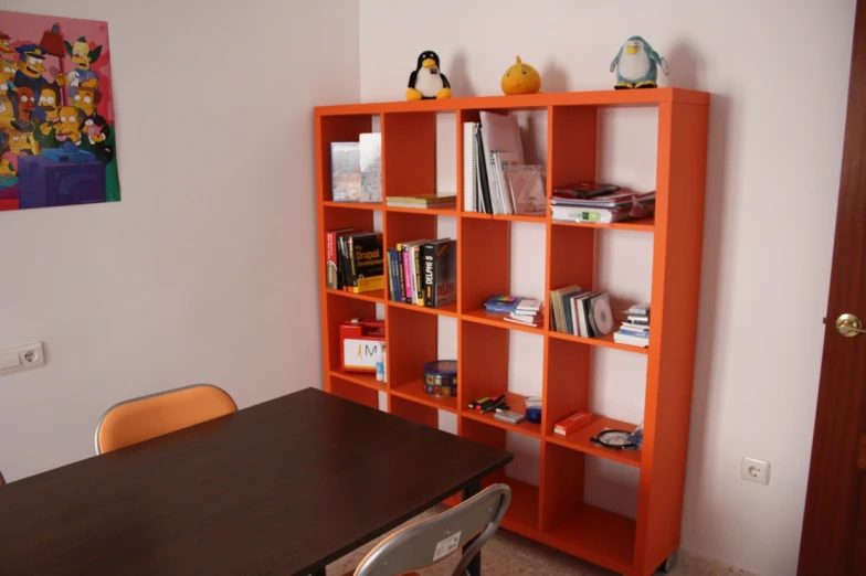 an orange shelf that is inside a home office