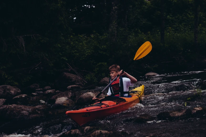 a man on a red kayak is out on the river