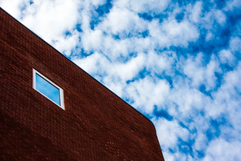 the sky is filled with fluffy clouds and blue square windows