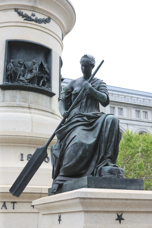 a statue of a woman with a gun and a case