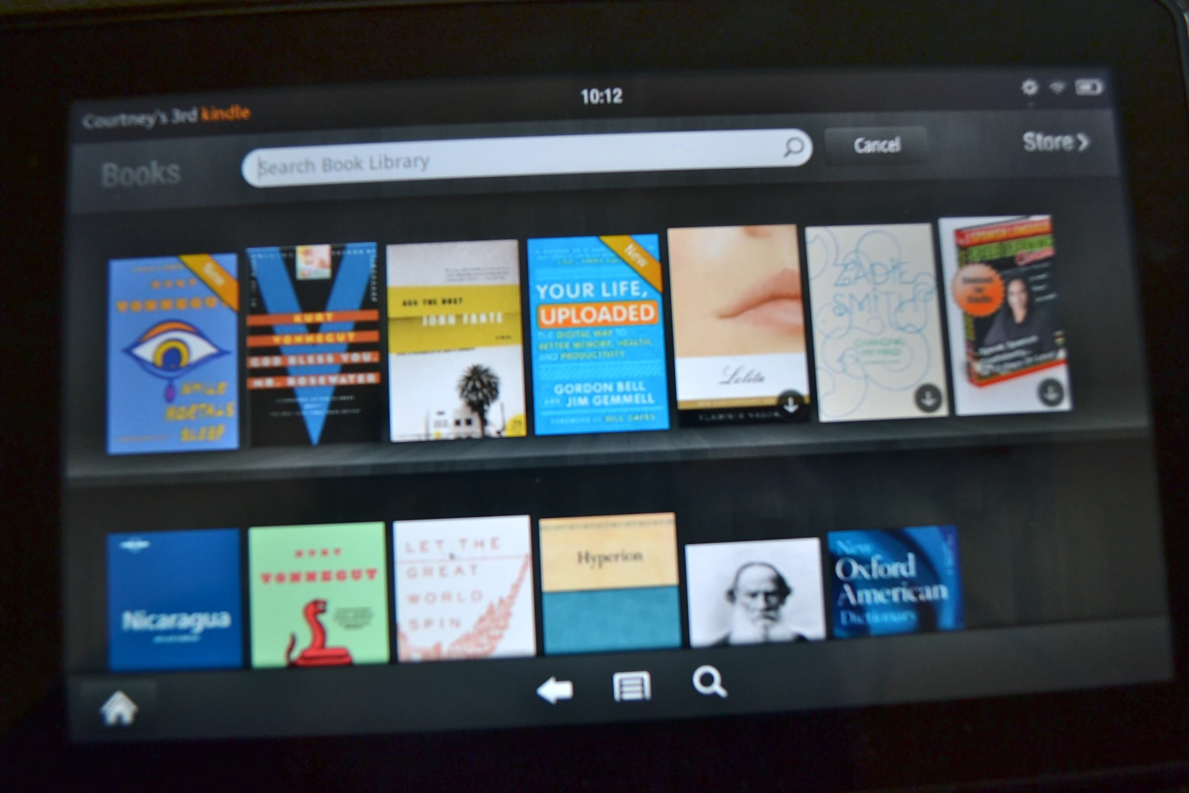 the kindle has multiple books on the shelves