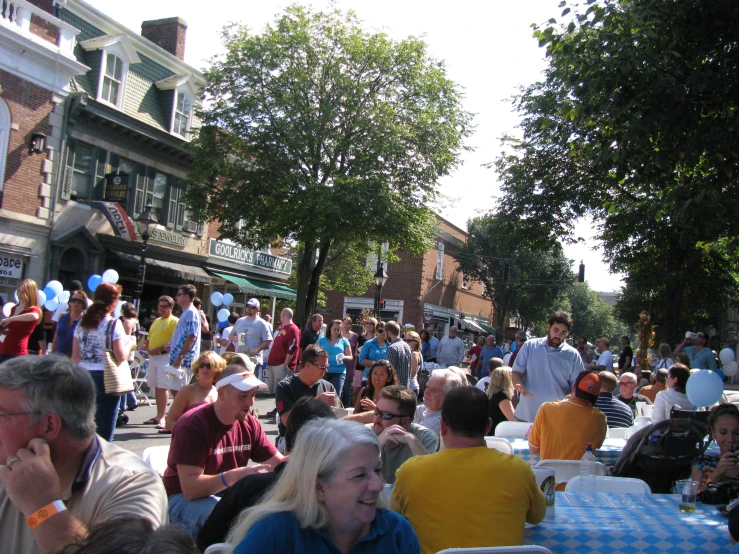 large group of people sitting outside in a crowded area