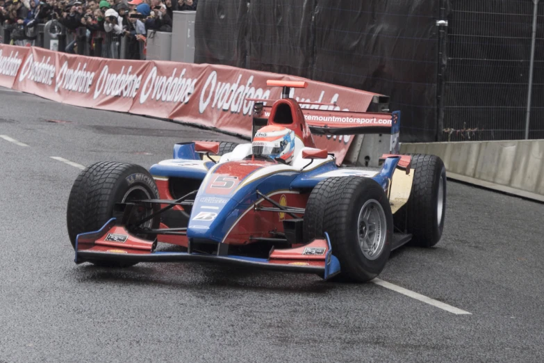 a race car drives around a corner on the track