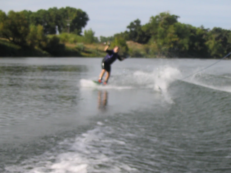 a man is skiing in the water holding onto ropes