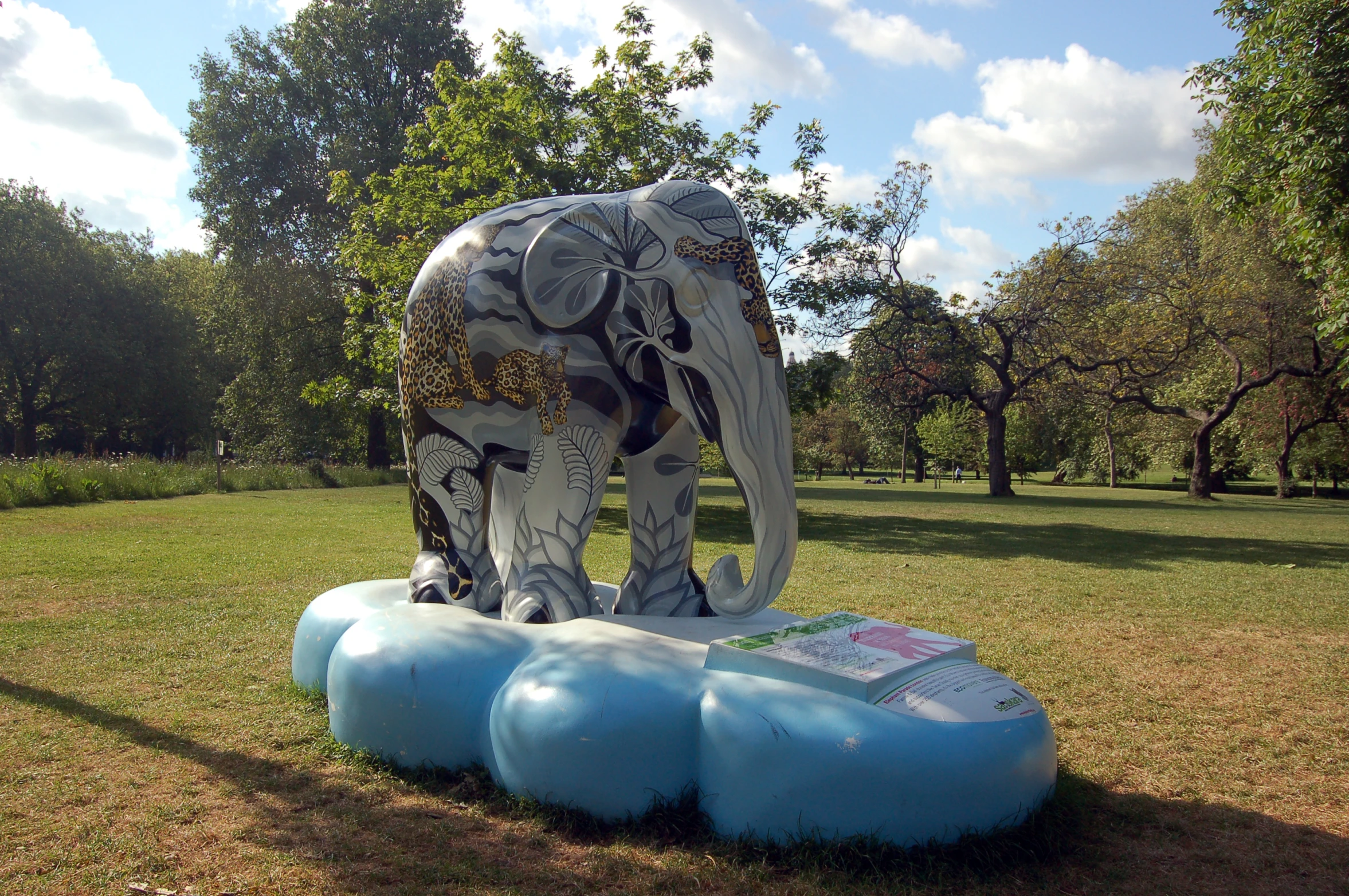 an elephant sculpture sits on top of some small balls