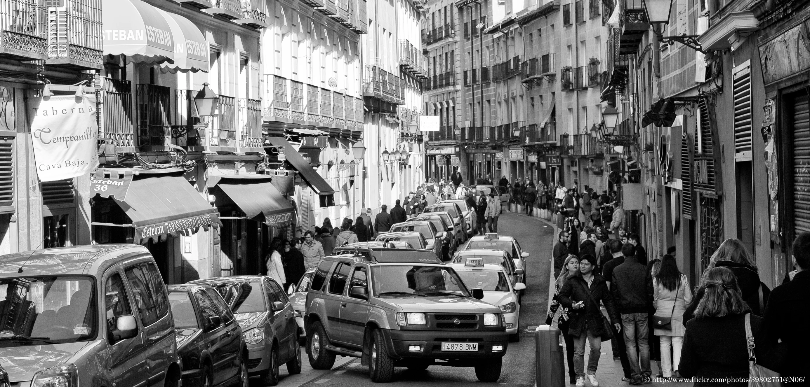 a black and white image of a crowded street