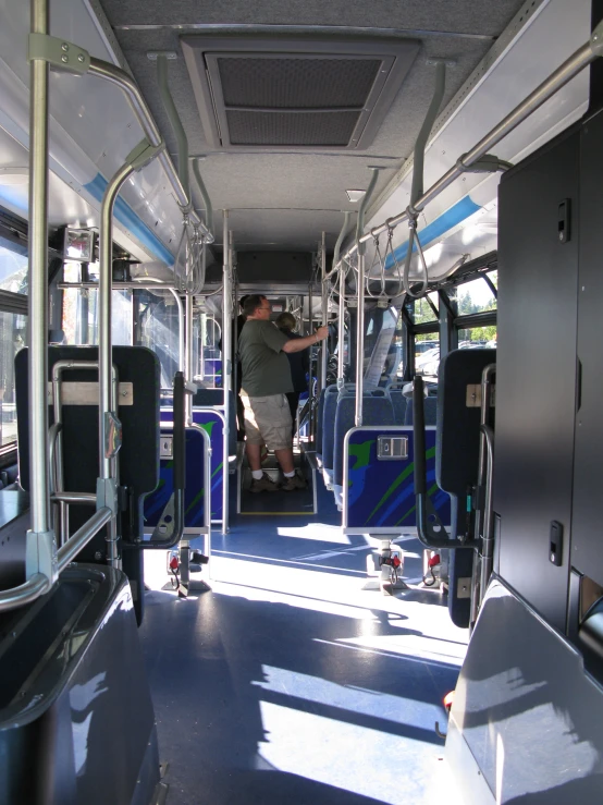 there is an empty bus with people standing on the inside