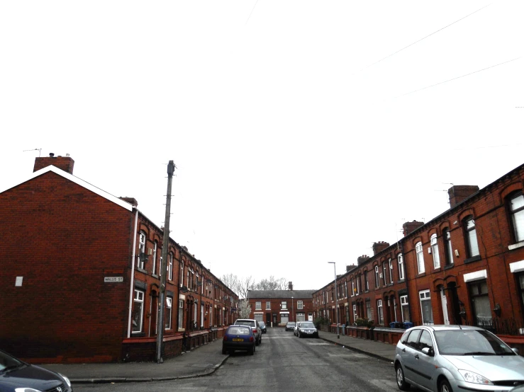 a small city street lined with parked cars