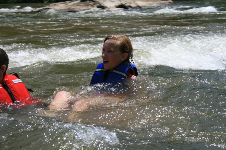 two children who are swimming in some water