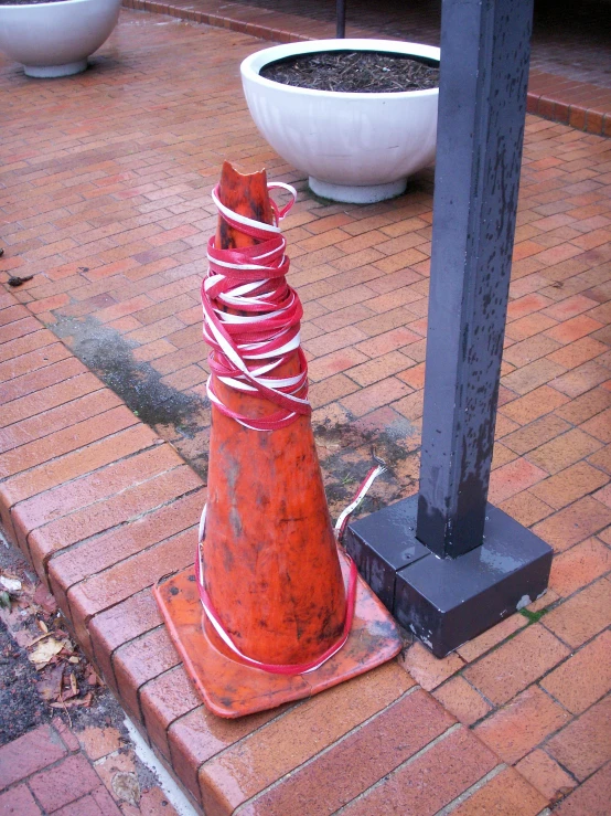 a small red cone wrapped in red string