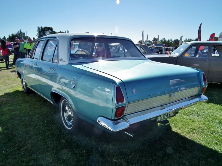 a blue station wagon car sitting next to others