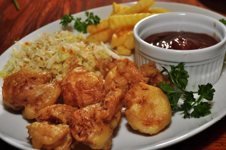 a plate with a bowl of dipping sauce and some fried food