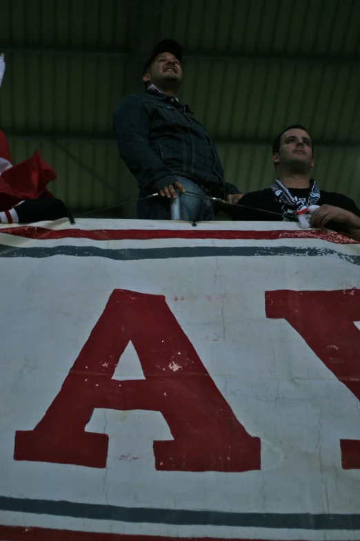 two men looking up at a big sign