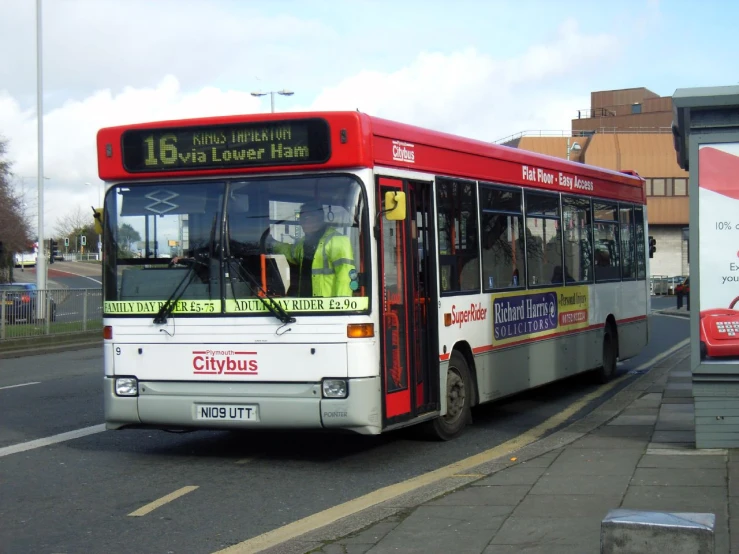 a bus is driving down the street with passengers on it