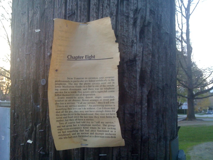 a scroll attached to a wooden post