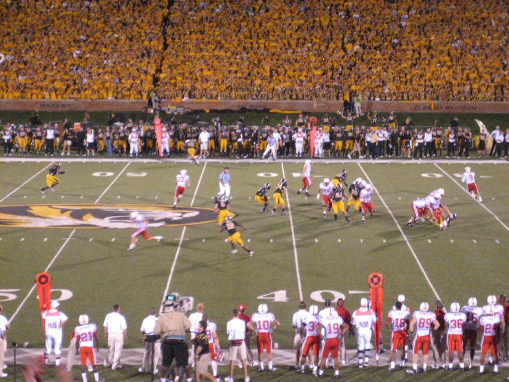 football game with many fans in the stands