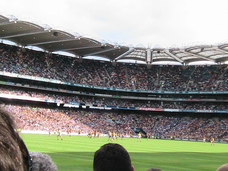 a huge crowd of people watching a soccer game