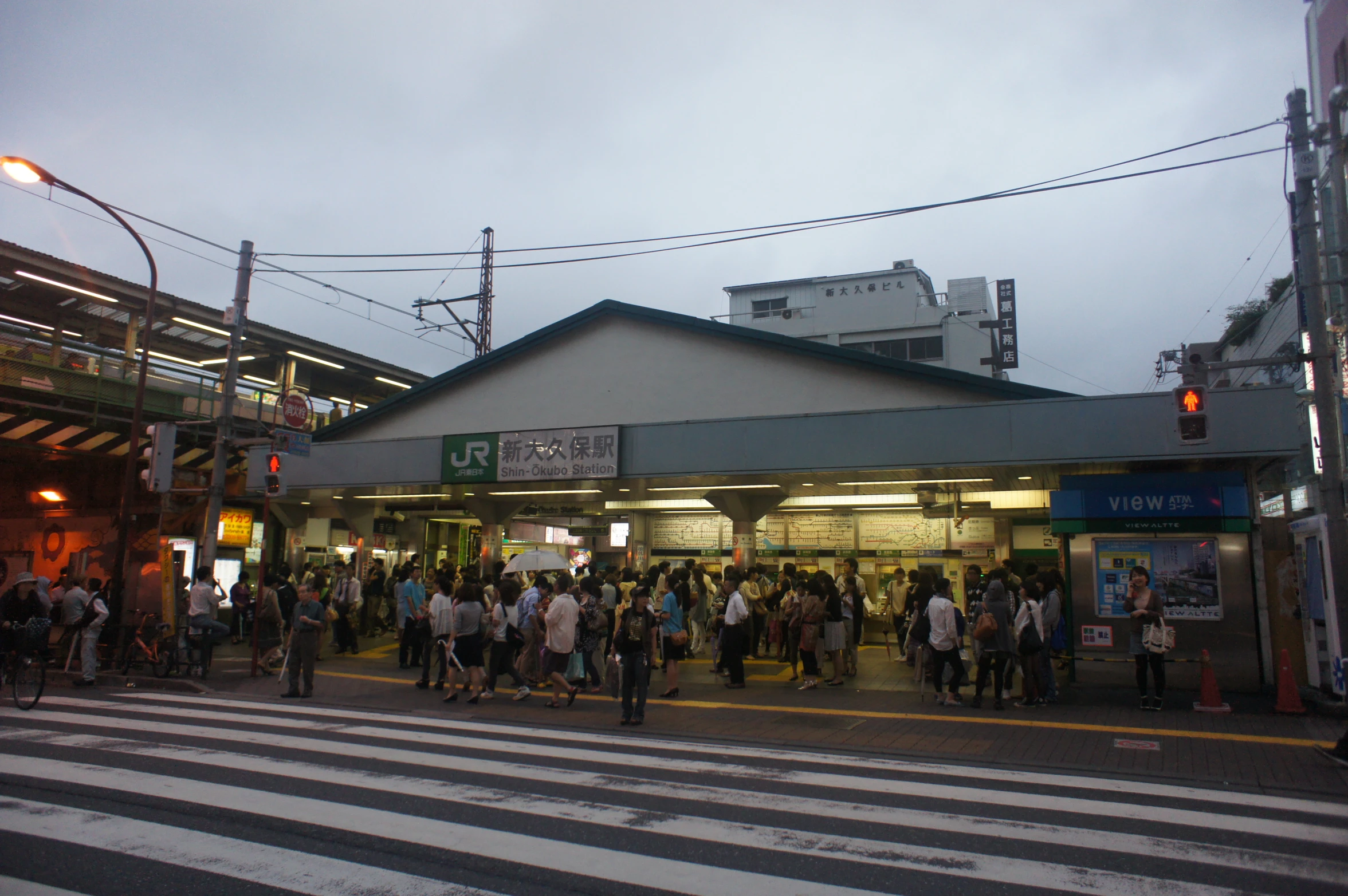 people gathered outside a building to board a train