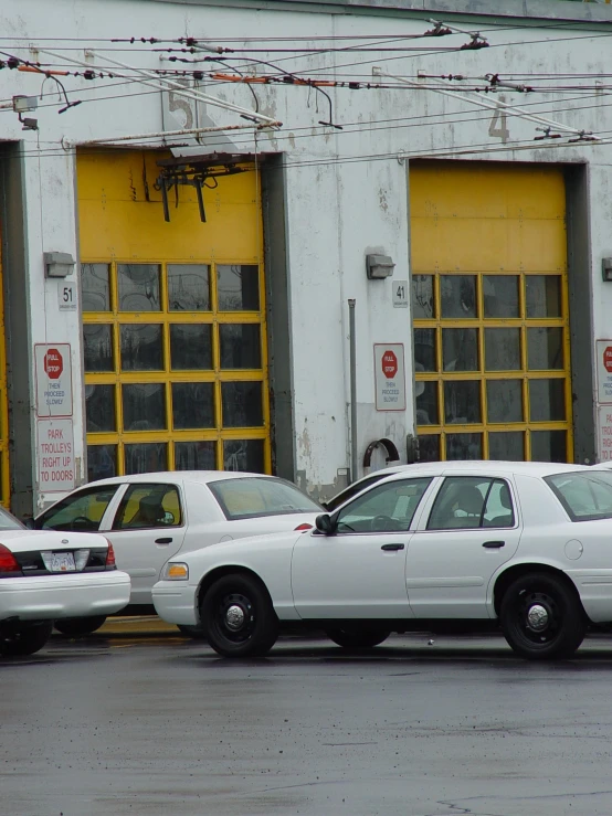 a row of parked police cars in front of buildings