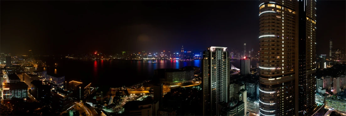 a city that is at night near some water