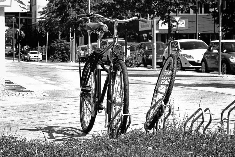 the bicycle is locked up and parked by the fence